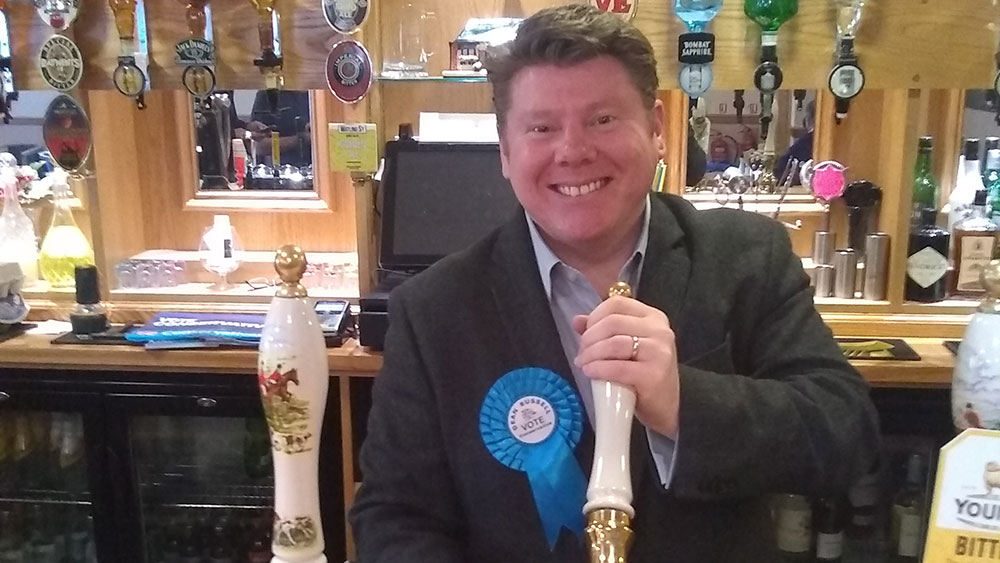 Dean Russell MP pulling a pint
